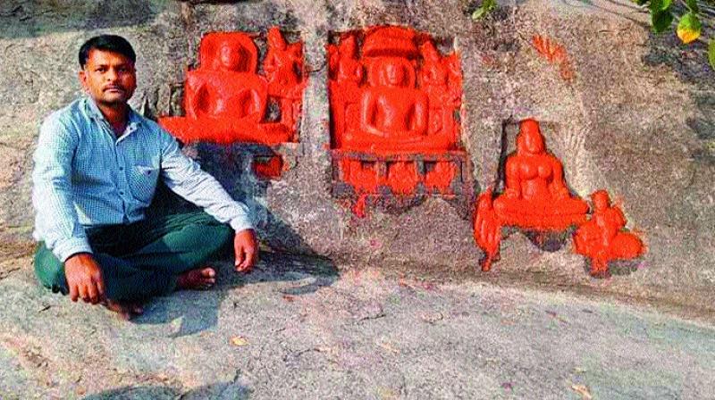 Historian Reddy Ratnakar Reddy with sculptures belonging to Jain Thirthankaras at Siddenki village.