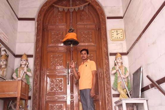 A caretaker of a Jain temple in New Delhi rings the bell for evening prayer. The Vatican sent greetings to Jains for their Mahavir Jayanti festival set for April 9.