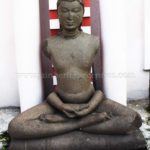 Ruined Tirthankar idol in padmasana - Jain Museum