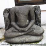 Ruined Tirthankar idol in padmasana - Jain Museum