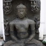 Ruined Tirthankar idol in padmasana - Jain Museum