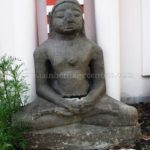 Ruined Tirthankar idol in padmasana - Jain Museum