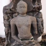 Ruined Tirthankar idol in padmasana - Jain Museum