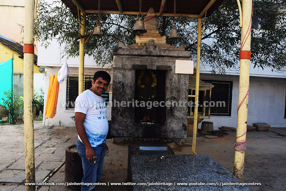 Researcher Nitin H P besides the Jattigaraya Mantapa of Dodda Basadi, Hassan.