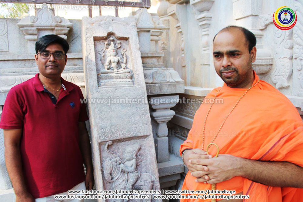 His Holiness SwastiSri Dr. Deevendrakeerthi Bhattarakha Swamiji and Researcher Dr. Ravikumar K Navalagunda besides the pillar inscription.